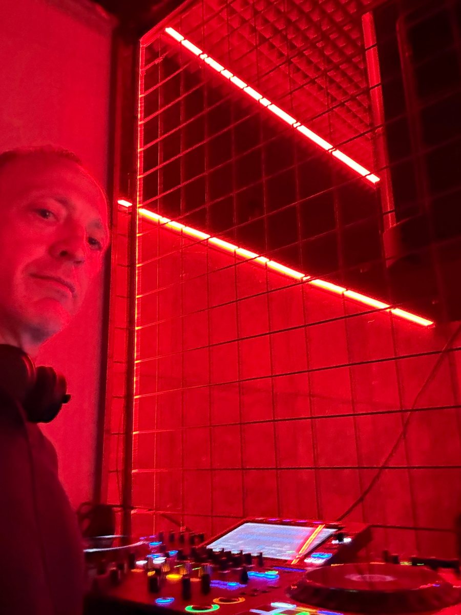 M4MMOTH in the red-lit DJ booth at RUST